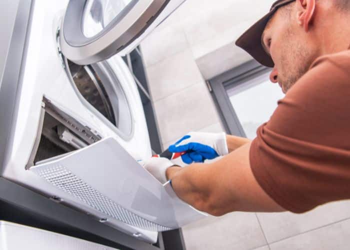 lint being cleaned out of dryer